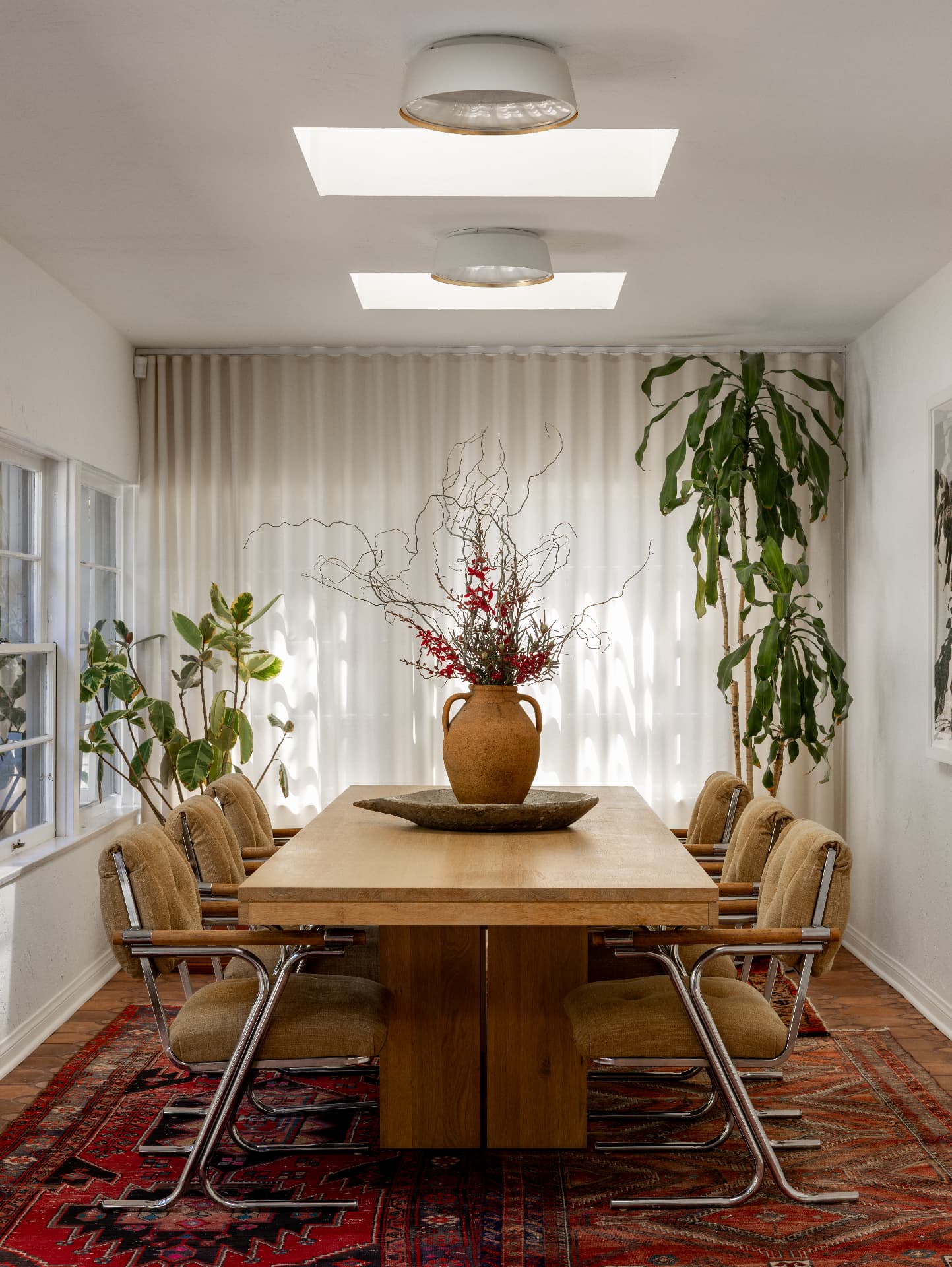 Solid white oak plank dining table under skylights