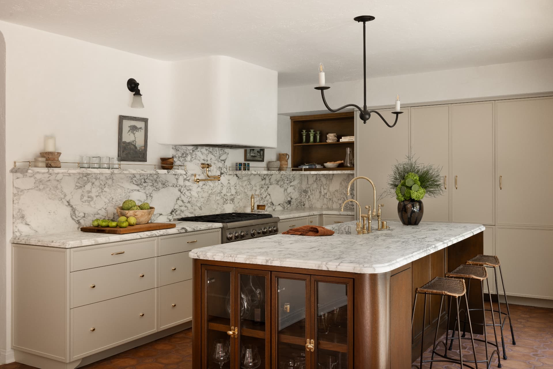 Kitchen with painted cabinetry, arabescato marble and a walnut island